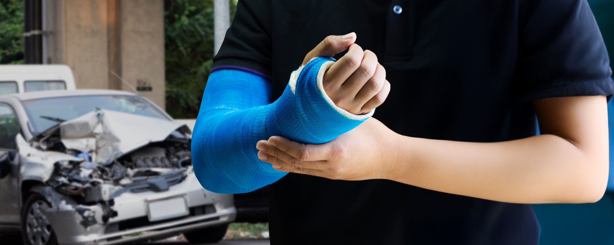 Man holding hand with blue bandage as arm injury with car accident concept