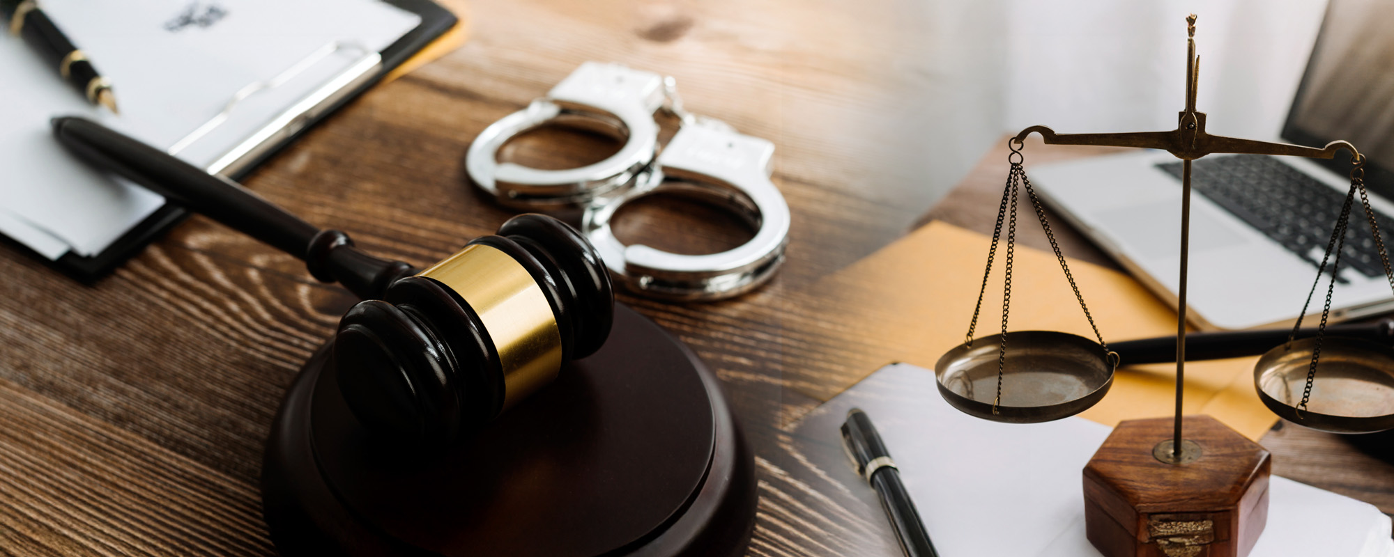 criminal lawyer theme with gavel skales and handcuffs on table