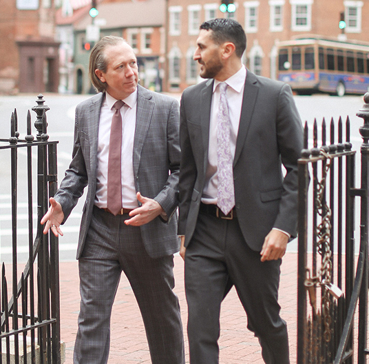 Prince George's County Injury & Criminal Lawyers Mike Berman & Jason Miller walking and talking to each other